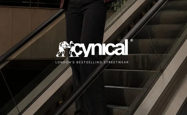 A model on an escalator with the cynical wordmark.